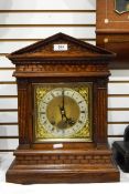 Late 19th century German mantel clock within architectural oak case, silvered chapter ring,