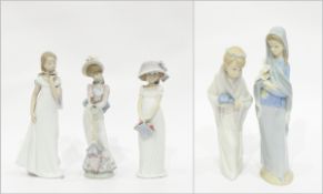 Group of Lladro figures including girl holding flower,