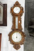 Late Victorian combination barometer within a carved oak case with clock, enamel dial,