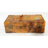 Vintage leather suitcase with various shipping labels,