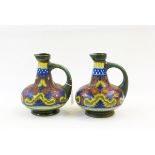 Pair Dutch R Hodian pottery ewers, each decorated with blue, yellow,