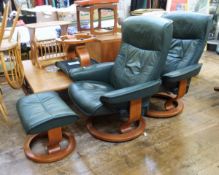 Pair of Ekornes leather revolving and reclining armchairs and matching footstools in dark green