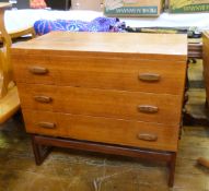 Mid 20th century G-Plan chest of three drawers with figured bar handles, on curved supports,