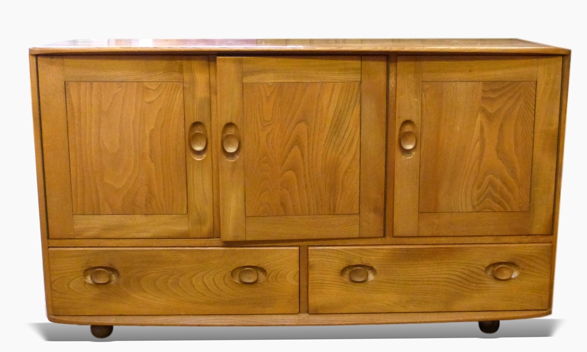 Ercol elm sideboard having slightly curved top, fitted three cupboards, with two drawers below,