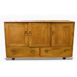 Ercol elm sideboard having slightly curved top, fitted three cupboards, with two drawers below,