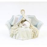 Naples porcelain figure of 19th century lady seated on sofa wearing bonnet,