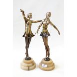 Two 1920's bronze-effect spelter dancing girls, each on circular stepped alabaster base, 35.