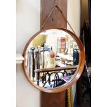 20th century teak and leather wall mirror, circular, plain with leather hanging cord,