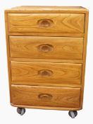 Ercol elm chest of four drawers, all with oval dished handles, on castors, 46.