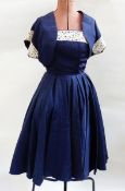 Blue satin 1950's cocktail gown, the bodice trimmed with lace and a bolero top,