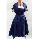 Blue satin 1950's cocktail gown, the bodice trimmed with lace and a bolero top,