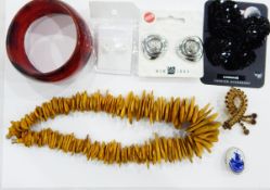 Large quantity of costume jewellery including an orange plastic bead necklace, a brass necklace,