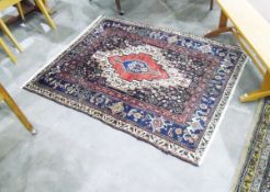 Eastern wool rug, with central red medallion within blue and cream borders,