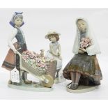 Lladro models of a Spanish dressed girl holding flowers,
