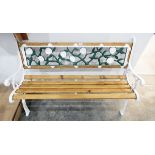 Slatted garden bench seat with painted decorative iron panelled back and standards