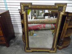 Late 19th century Arts and Crafts wall mirror, of shaped rectangular form,