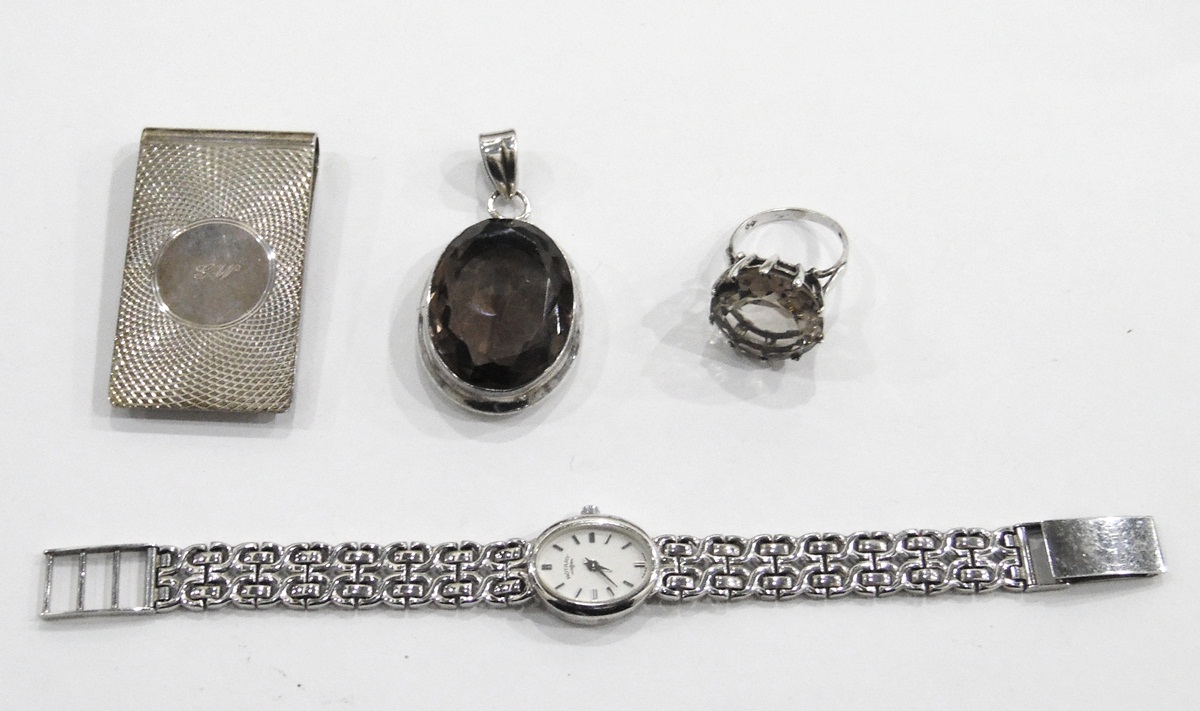 Silver money clip with engine turned decoration, a silver and smoky quartz dress ring,