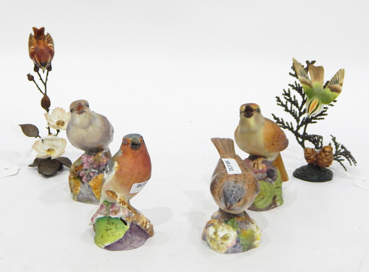 Three tinted bisque Royal Worcester models of birds and another glazed,