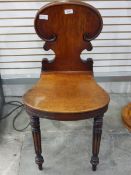 Pair of 19th century mahogany hall chairs with shaped back and on turned and fluted supports