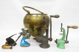 Brass coal bucket of ovoid form, on three paw feet and contents including two coffee grinders, etc.