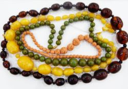 Graduated amber-effect plastic bead necklace, three further similar examples,