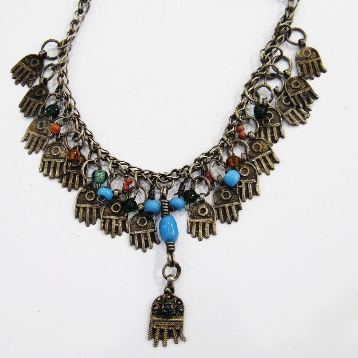 North African white metal necklace hung with glass beads and hamsa hand charms