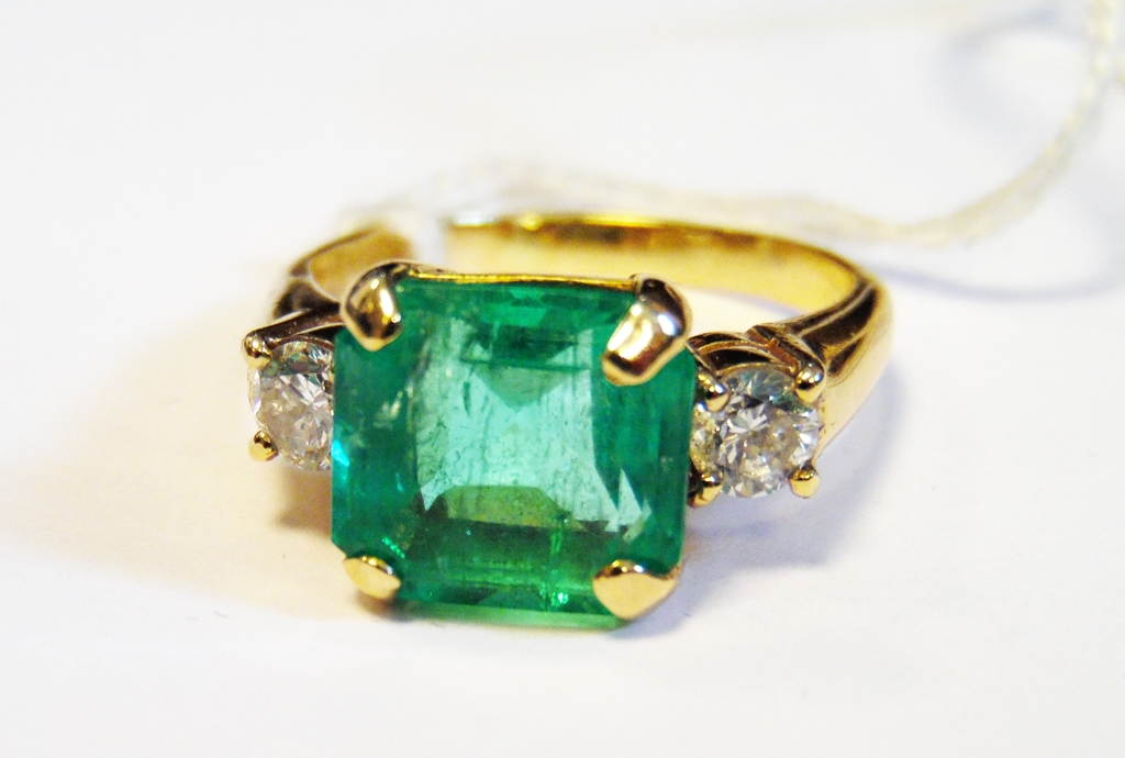 Gold-coloured, diamond and emerald three-stone ring,