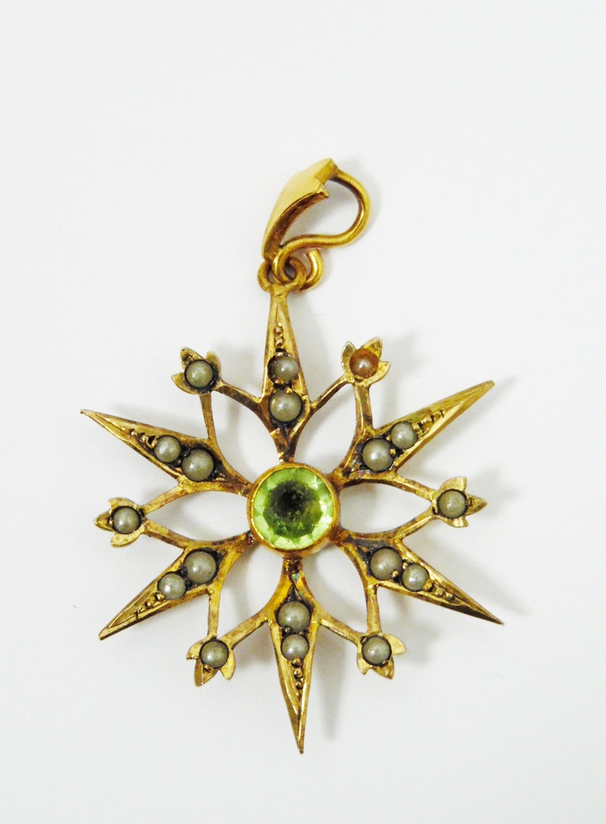 Early 20th century gold-coloured pendant of star design set with a central circular mixed cut