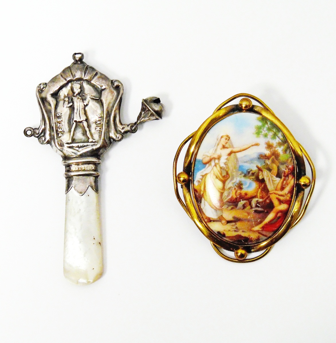 Victorian brooch with central printed porcelain oval depicting figures on a coastline,