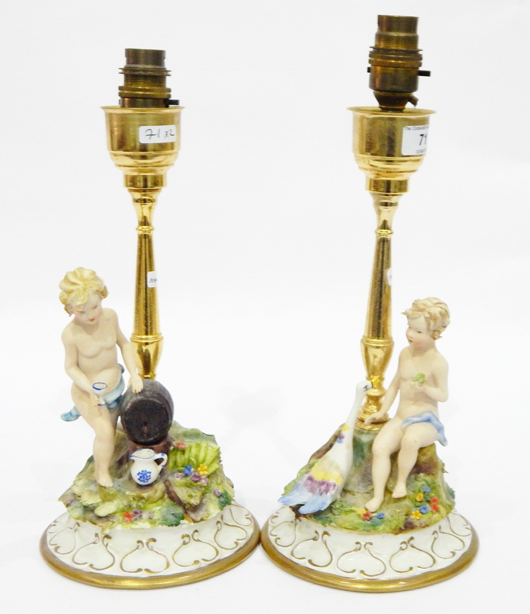 Pair of Capodimonte tinted bisque and gilt metal figure lamp stands,