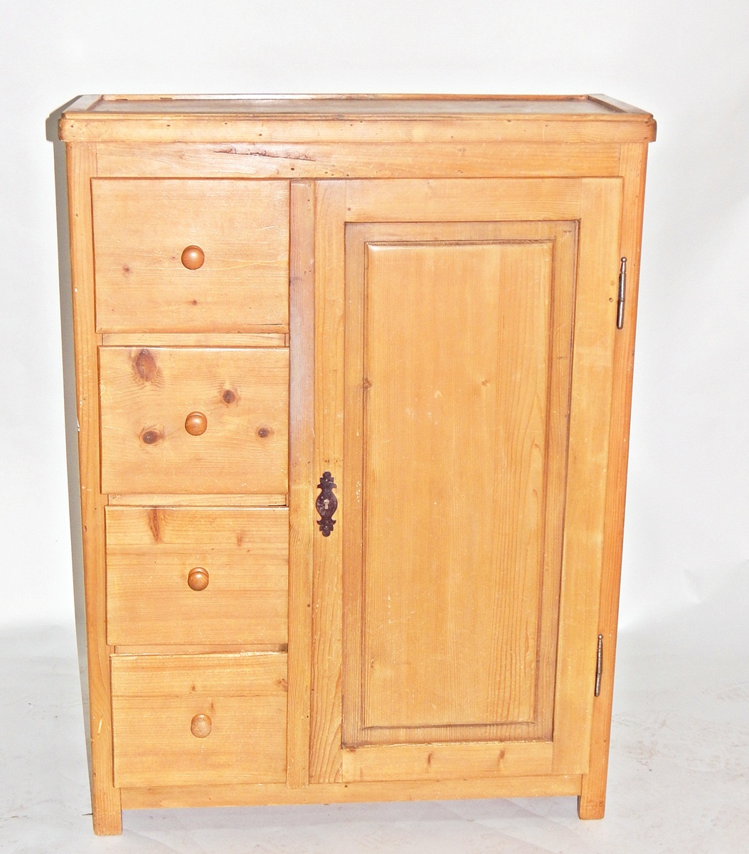 Pine cupboard incorporating four drawers with turned knob handles,