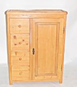 Pine cupboard incorporating four drawers with turned knob handles,
