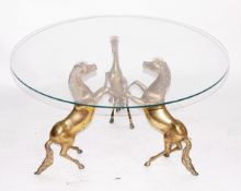 Coffee table, the circular glass top supported by three rearing brass horses,