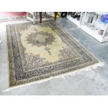 Eastern wool rug, with central floral medallion on a pale green ground with multiple borders,