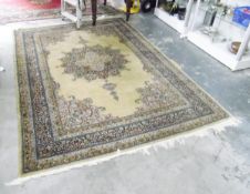 Eastern wool rug, with central floral medallion on a pale green ground with multiple borders,