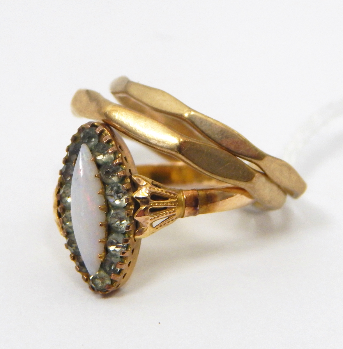 Edwardian 9ct gold opal and paste ring of marquise-shape with central opal surrounded by a border