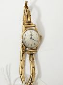 Lady's Tissot gold-coloured strap watch on rolled gold expanding bracelet,