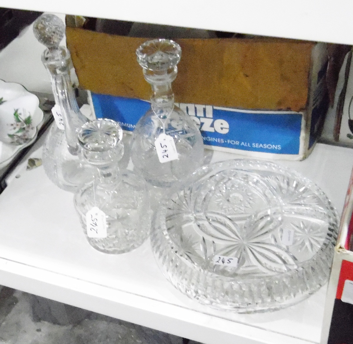 Quantity of assorted cut glass including a large squat-form fruit bowl, three decanters,