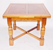 Circa 1930's oak-finish draw-leaf dining table on turned supports and cross-stretchers and five