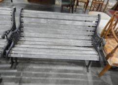 Pair of slatted garden bench seats with decorative iron supports