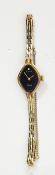 Avia lady's gold plated evening watch with black dial set with a diamond and a link bracelet
