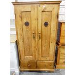 Old pine two-door food cupboard having two drawers to base and standing on turned bun feet,