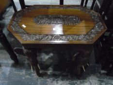 Anglo Indian carved teak octagonal occasional table standing on four elephant mask heads,