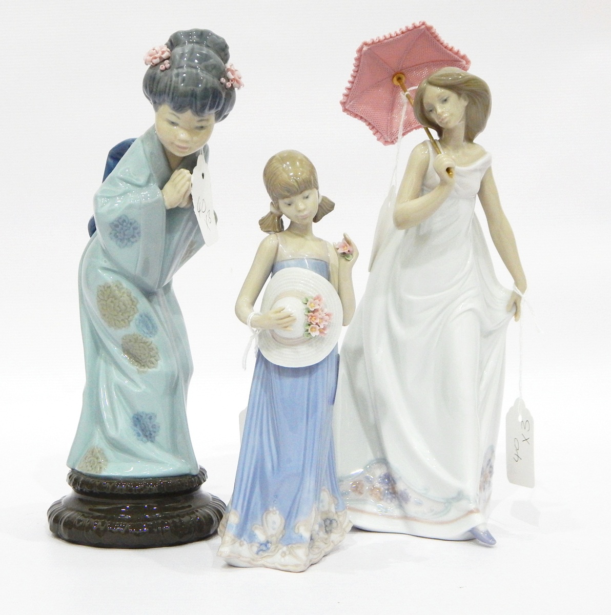 Collection of three Lladro figures including young girl with hat,
