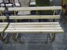 Pair of pine slat back and seated garden bench seats on gilt painted ornate cast iron supports,