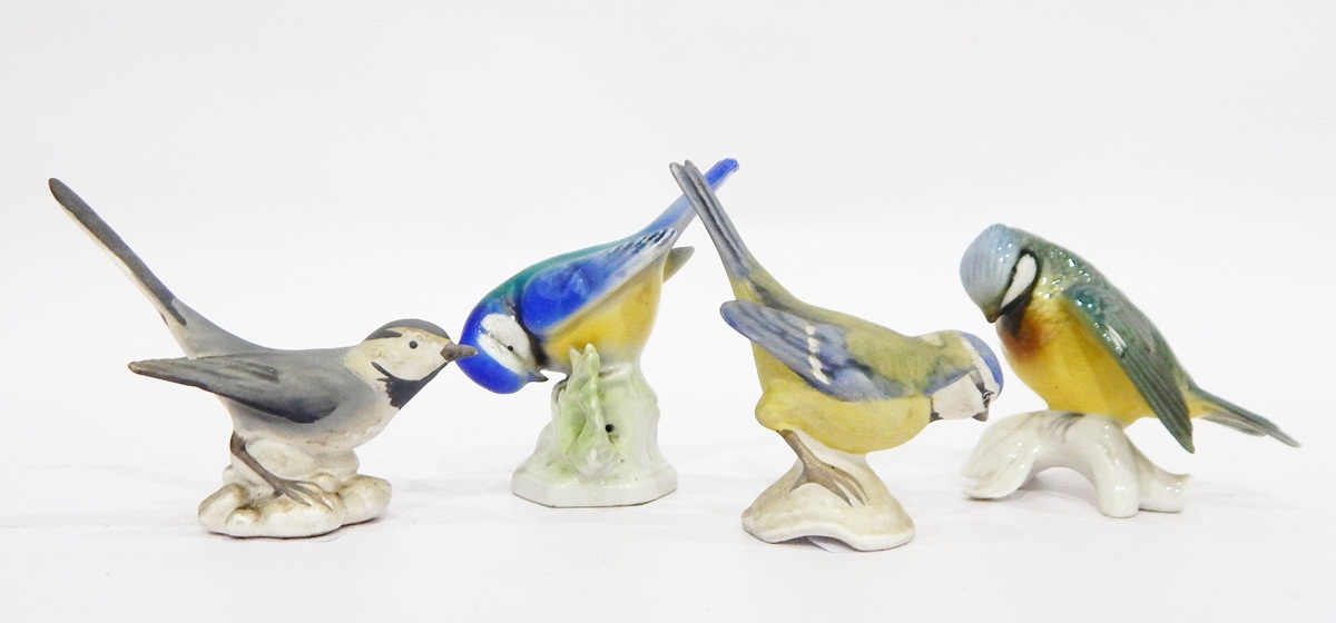 Two Goebel tinted bisque model birds and two other German glazed models (4)