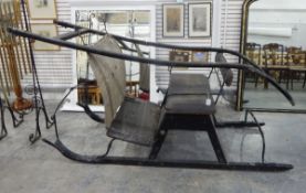 19th century horse-drawn sleigh with upholstered bench seat and front wicker panel