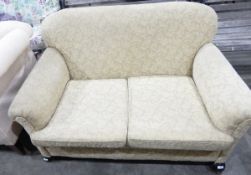 Two-seat settee having bun feet and castors