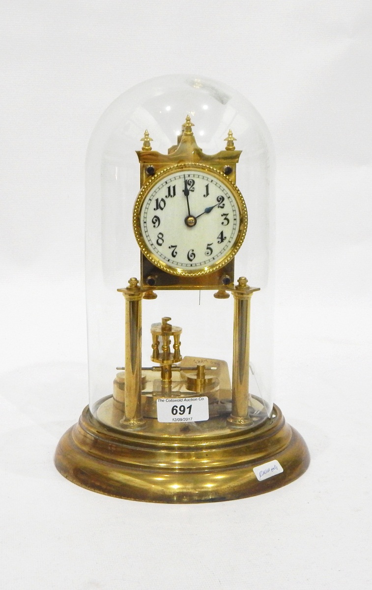 Modern brass skeleton clock with circular ivorine dial, on brass circular base with glass dome,