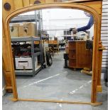 Pine overmantel mirror of rectangular form with arched top,